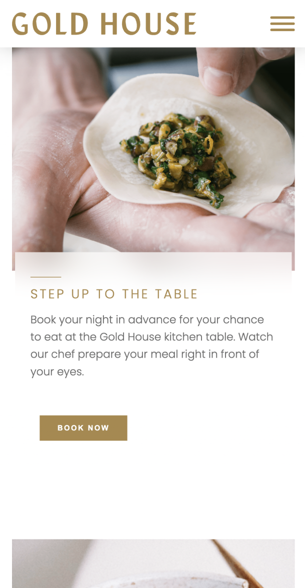 Mobile view of the gold-house website with headline 'step up to the table' and someone wrapping a dumpling