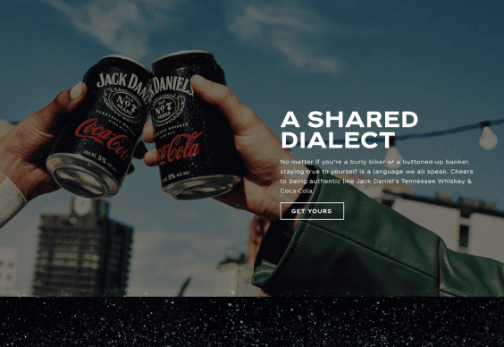 Brand storytelling section featuring two people toasting with Jack Daniel’s & Coca-Cola cans