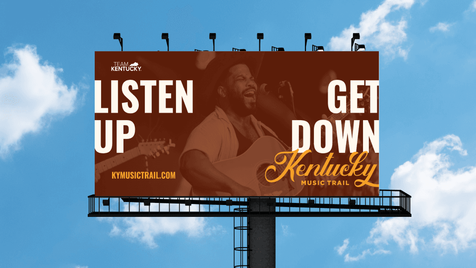 Billboard photo showing Listen Up Get Down campaign against blue sky