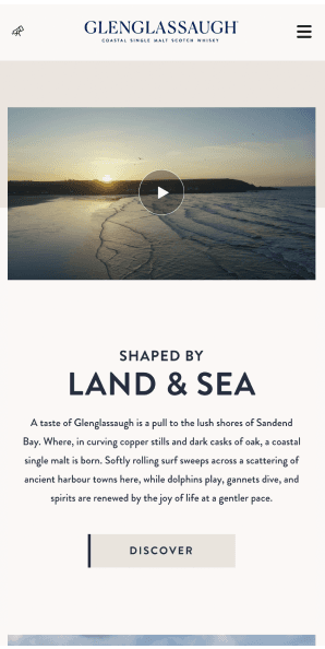Mobile Shaped by Land and Sea page featuring sunset beach video and brand storytelling