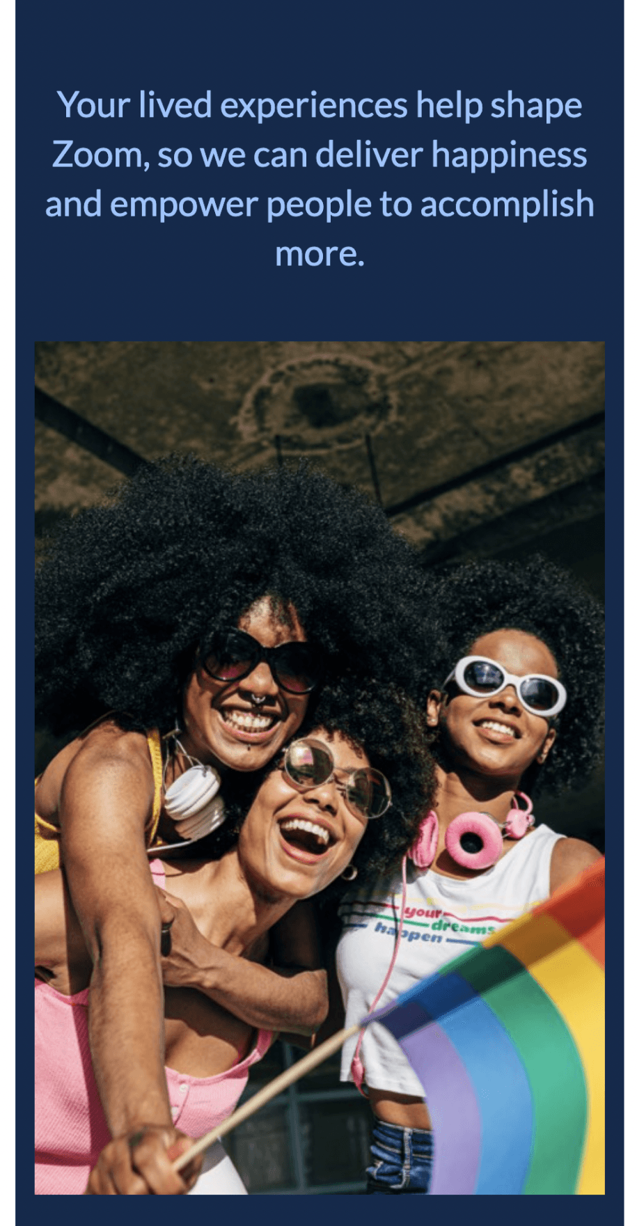 Mobile view showing three diverse women celebrating with Pride flag