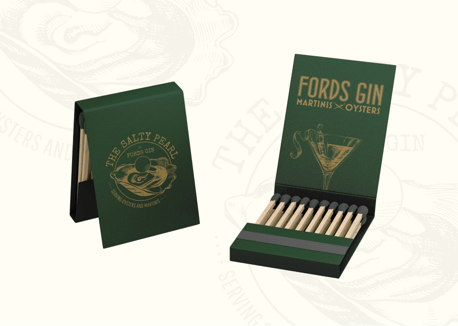 Custom branded matchbooks featuring The Salty Pearl oyster illustration and Ford’s Gin martini artwork