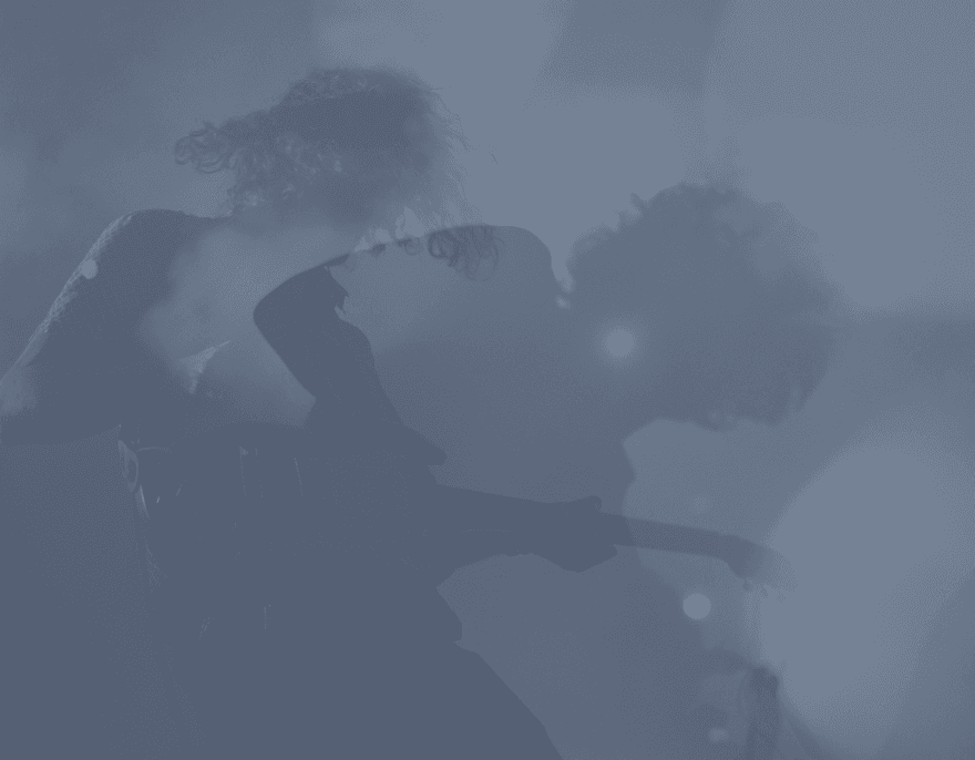 Silhouette of musicians performing on stage in atmospheric blue lighting