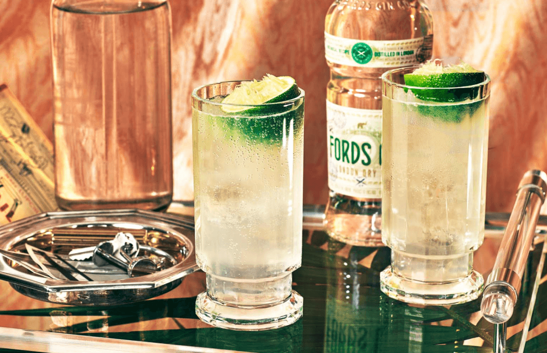 Lifestyle photography of Ford’s Gin cocktails on a brass bar cart with elegant glassware