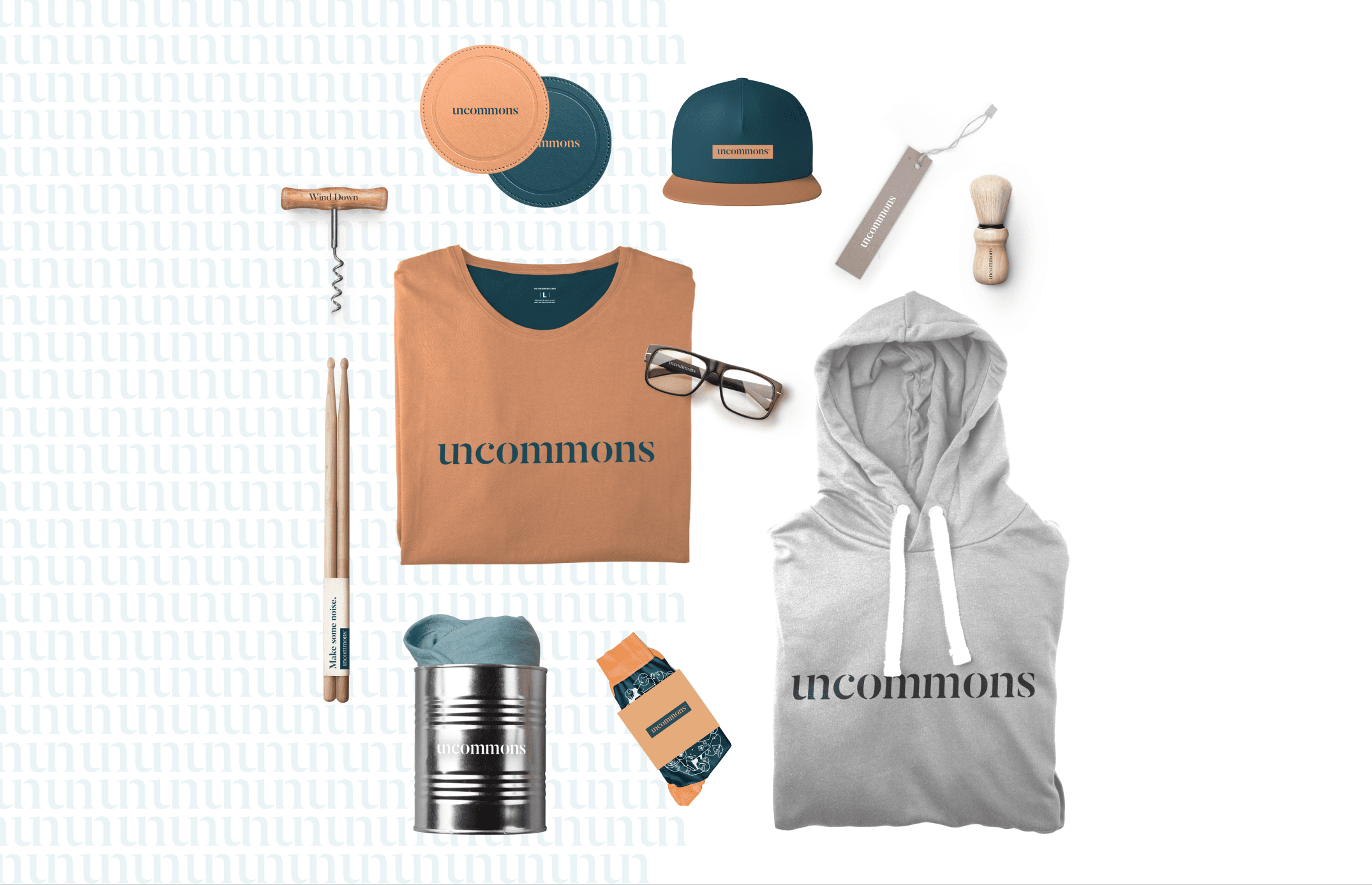 Branded apparel and merchandise flat lay featuring t-shirts, hoodie, hat, and accessories