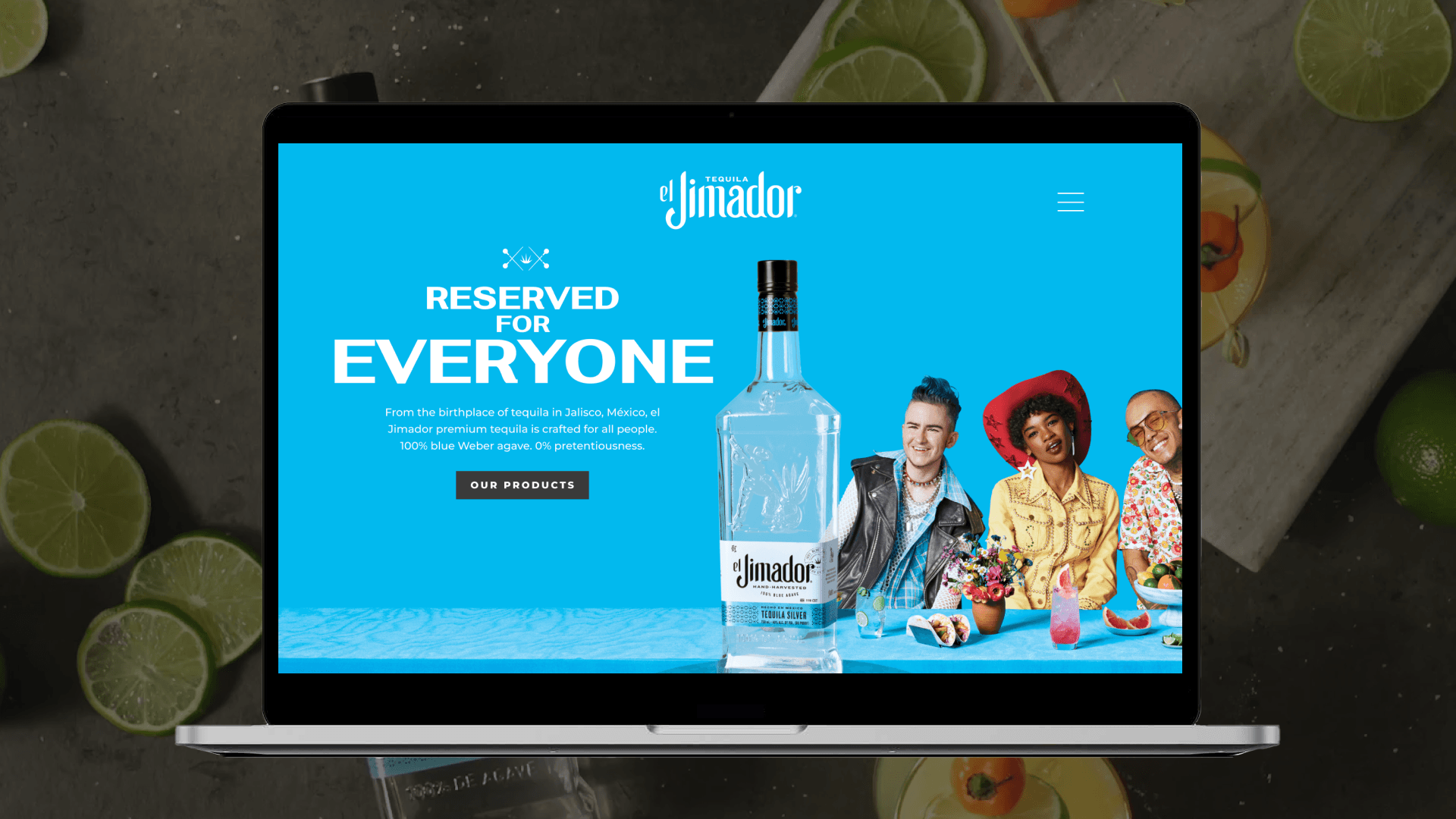Laptop mockup displaying the el Jimador website homepage surrounded by fresh limes