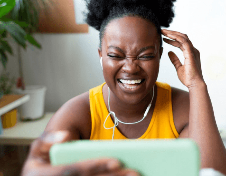 Woman smiling joyfully during a video call on her smartphone
