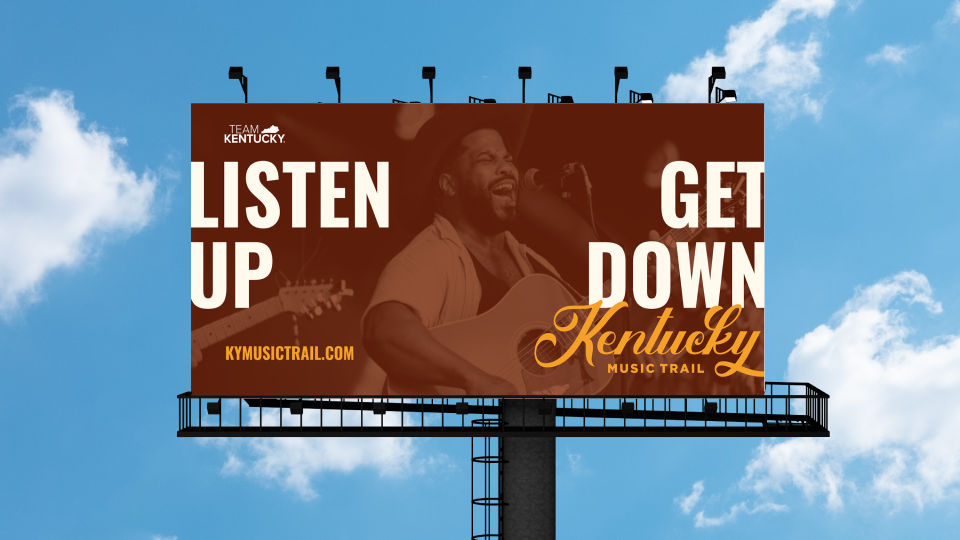 A billboard mockup featuring a Kentucky Music Trail ad. The billboard reads