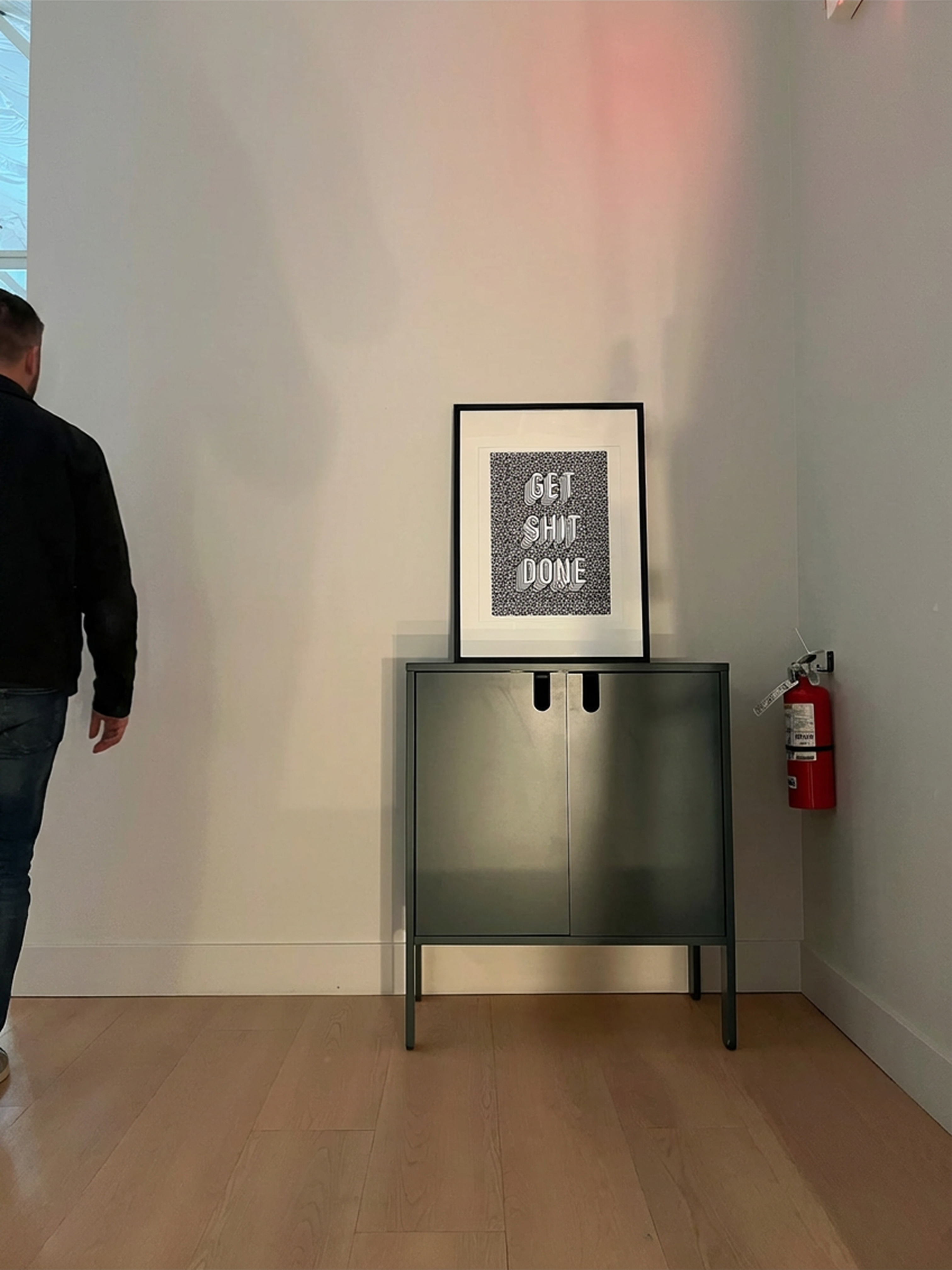 Get Shit Done motivational artwork on office wall